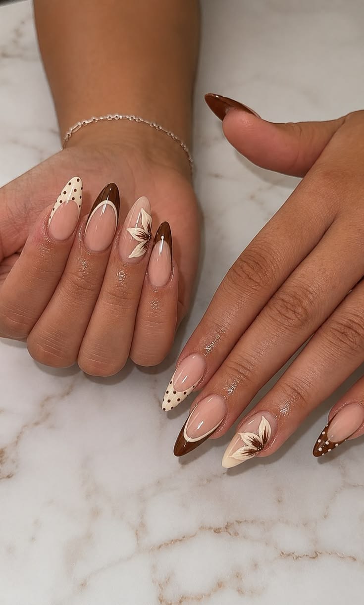 Almond nails with brown and cream French tips, polka dots and a painted flower