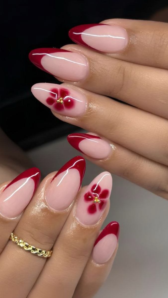 Almond nails with red French tips and a red flower design