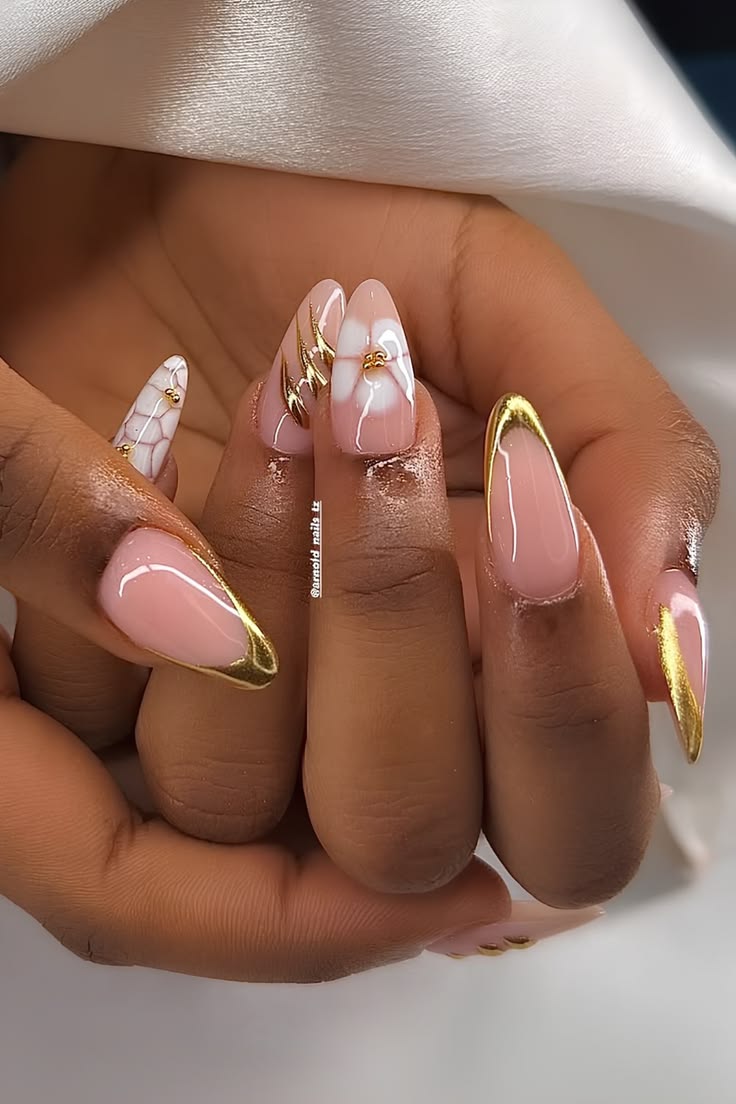 Almond nails with gold chrome French tips and floral accents